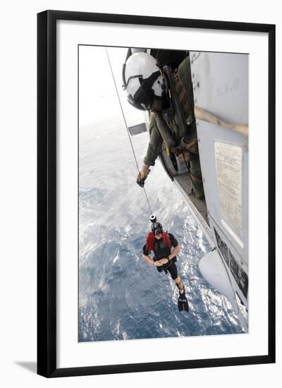 Aircrewman Assists in Hoisting a Member into an Mh-60S Sea Hawk-null-Framed Photographic Print