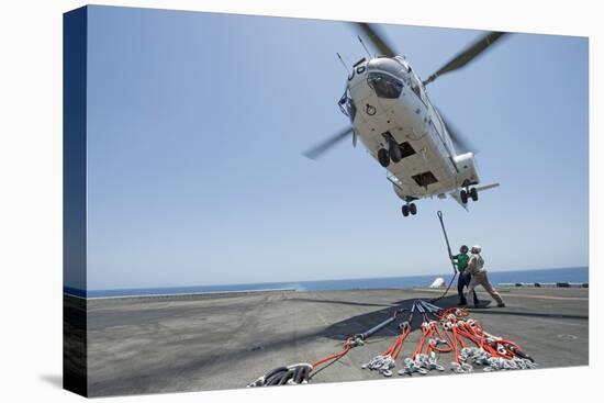 Airmen Attach a Cargo Hook to an SA-330J Puma Helicopter-null-Stretched Canvas