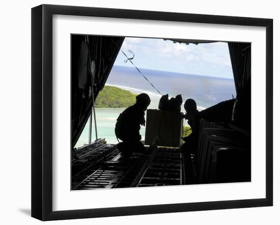 Airmen Push Out a Pallet of Donated Goods from a C-130 Hercules-Stocktrek Images-Framed Photographic Print