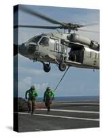 Airmen Run to Cover after Attaching Cargo Legs to an Mh-60S Sea Hawk-null-Stretched Canvas