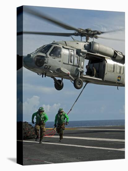 Airmen Run to Cover after Attaching Cargo Legs to an Mh-60S Sea Hawk-null-Stretched Canvas