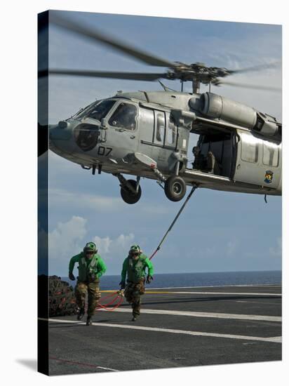 Airmen Run to Cover after Attaching Cargo Legs to an Mh-60S Sea Hawk-null-Stretched Canvas