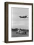 Airplane Flying over Race Car in Action-null-Framed Photographic Print