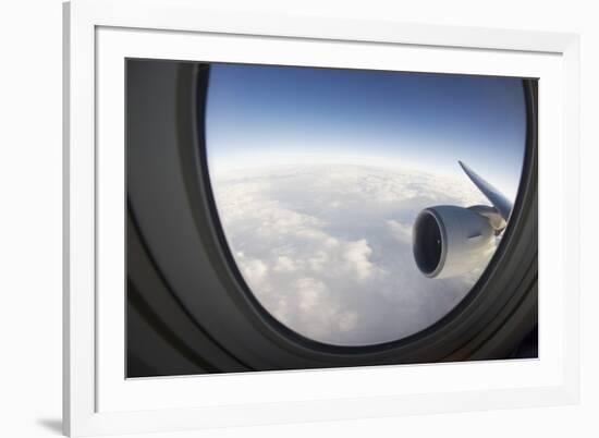 Airplane Window Looking Out on Cloudy Sky-Paul Souders-Framed Photographic Print