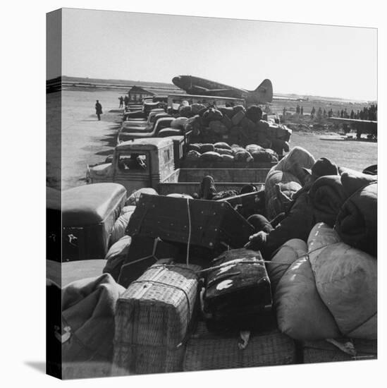 Airplanes Sitting on Airstrip at Airfield and Supplies Sitting in Trucks-Jack Birns-Stretched Canvas