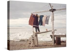 Alaskan Woman Hanging Her Laundry to Dry Along the Edge of an Ice Sheet-Ralph Crane-Stretched Canvas