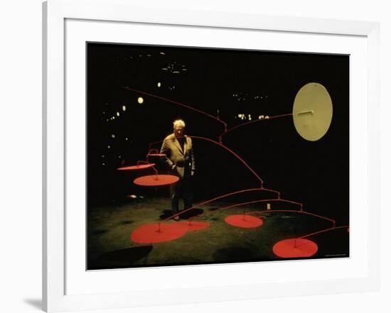 Alexander Calder Walking Past Exhibit of His Mobiles at the Guggenheim Museum-Gjon Mili-Framed Premium Photographic Print