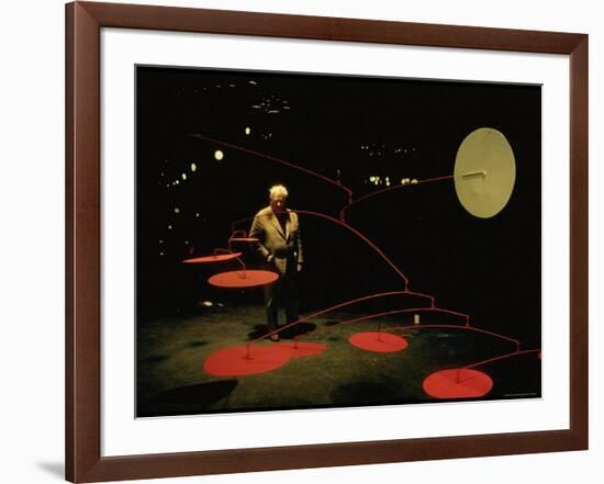 Alexander Calder Walking Past Exhibit of His Mobiles at the Guggenheim Museum-Gjon Mili-Framed Premium Photographic Print