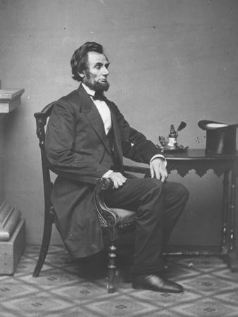 Abraham Lincoln, full-length portrait, seated, 1861