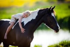 Child Sits On A Horse In Meadow Near Small River-Alexia Khruscheva-Stretched Canvas