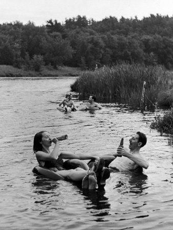 Couple Drinking Beer at Inner Tube Floating Party on the Apple River