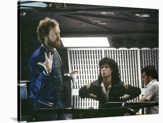 Alien, 1979 directed by Ridley Scott On the set; the director (Ridley Scott) with Sigourney Weaver -null-Stretched Canvas