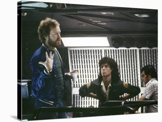 Alien, 1979 directed by Ridley Scott On the set; the director (Ridley Scott) with Sigourney Weaver -null-Stretched Canvas