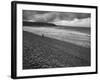 Along British Coastline, Woman Walking on Pebbled Shore-Nat Farbman-Framed Photographic Print