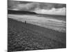 Along British Coastline, Woman Walking on Pebbled Shore-Nat Farbman-Mounted Photographic Print