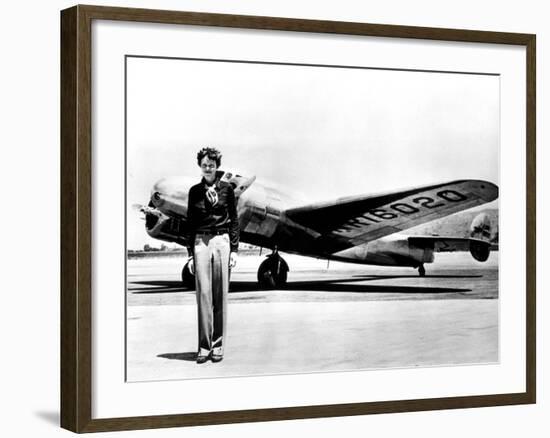 Amelia Earhart Standing in Front of the Lockheed Electra in Which She Disappeared in July 29, 1937-null-Framed Photo