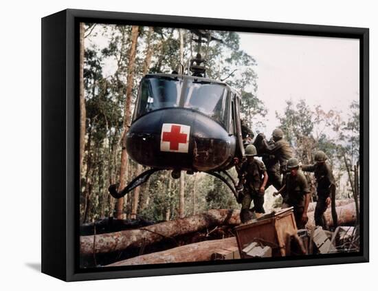 American 4th Battalion, 173rd Airborne Brigade Soldiers Loading Wounded Onto a "Huey" Helicopter-Alfred Batungbacal-Framed Stretched Canvas