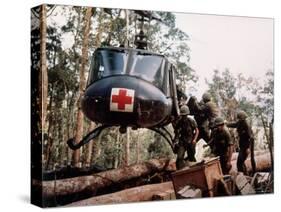 American 4th Battalion, 173rd Airborne Brigade Soldiers Loading Wounded Onto a "Huey" Helicopter-Alfred Batungbacal-Stretched Canvas