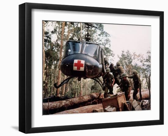 American 4th Battalion, 173rd Airborne Brigade Soldiers Loading Wounded Onto a "Huey" Helicopter-Alfred Batungbacal-Framed Photographic Print