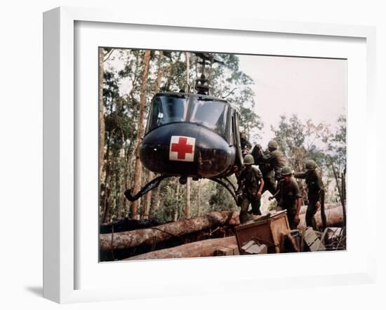 American 4th Battalion, 173rd Airborne Brigade Soldiers Loading Wounded Onto a "Huey" Helicopter-Alfred Batungbacal-Framed Photographic Print