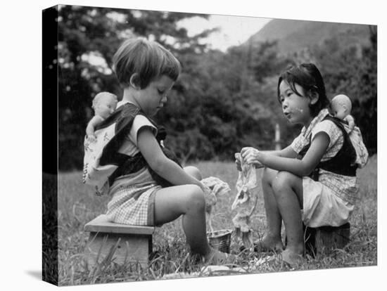 American Child Playing with Chinese Friend, Washing Doll Clothes-John Dominis-Stretched Canvas