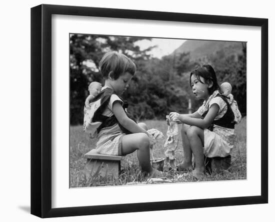 American Child Playing with Chinese Friend, Washing Doll Clothes-John Dominis-Framed Photographic Print