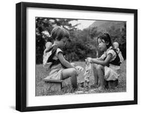 American Child Playing with Chinese Friend, Washing Doll Clothes-John Dominis-Framed Photographic Print