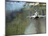 American F4C Phantom Jet Firing Rockets into Viet Cong Stronghold village During the Vietnam War-Larry Burrows-Mounted Photographic Print