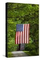 American Flag Hanging Above Gravel Road-Paul Souders-Stretched Canvas