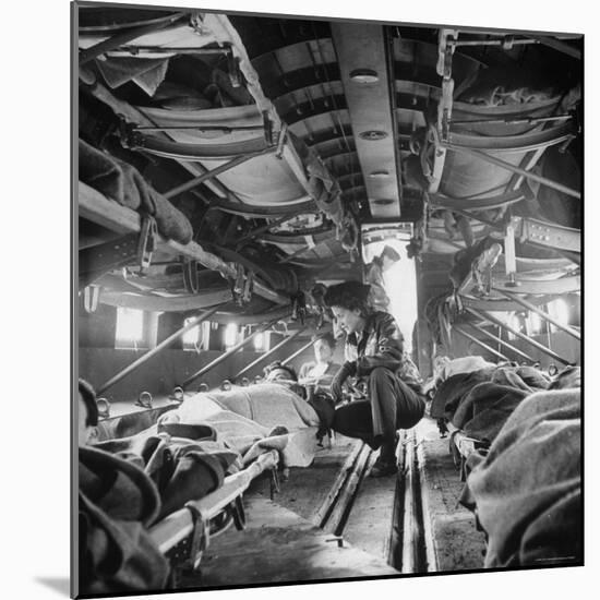 American "Flying Nurse", Julia Corinne Riley, Checks on Patients Aboard C-47 Transport Plane-Eliot Elisofon-Mounted Photographic Print