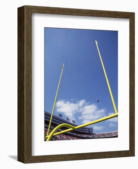 American Fooball Flying Through the Goalposts-null-Framed Photographic Print