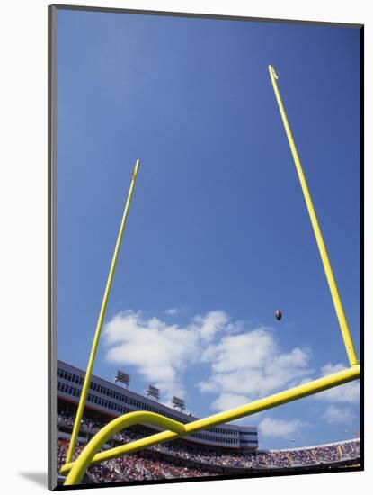 American Fooball Flying Through the Goalposts-null-Mounted Photographic Print