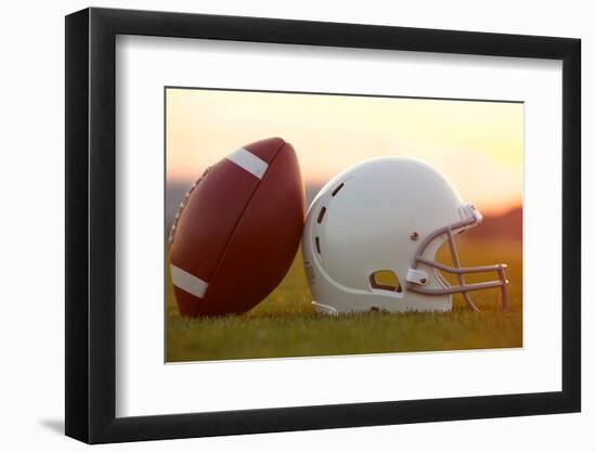 American Football and Helmet on the Field at Sunset-33ft-Framed Photographic Print
