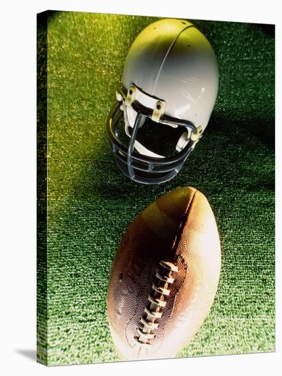 American Football Helmet and a Football-null-Stretched Canvas