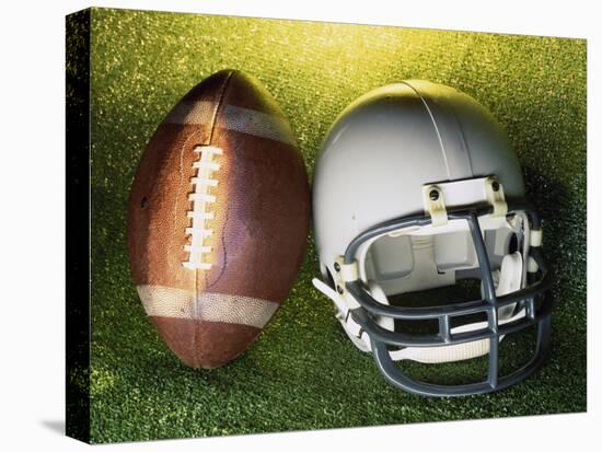 American Football Helmet and a Football-null-Stretched Canvas