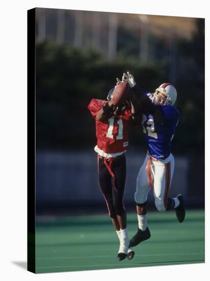 American Football Player Reaching for the Ball-null-Stretched Canvas