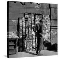 American GI Perusing Book Vendors' Stand during WWII-Robert Capa-Stretched Canvas