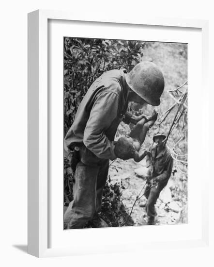 American Lieutenant Carrying Micronesian Baby He Found in cave Japanese Soldiers Holed Up There-W^ Eugene Smith-Framed Photographic Print