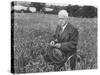American Poet, Robert Frost Standing in Meadow During Visit to the Gloucester Area of England-Howard Sochurek-Stretched Canvas