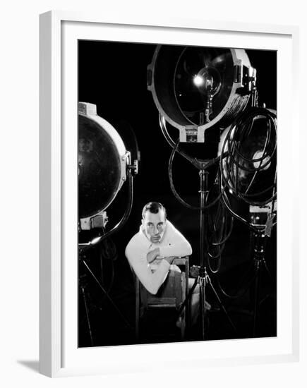 American silent screen comedian and actor Buster Keaton (1895 - 1966) surrounded by studio lighting-null-Framed Photo