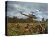 American UH1 Huey Helicopter Lifting Off as Personnel on the Ground Protect Themselves-Larry Burrows-Stretched Canvas