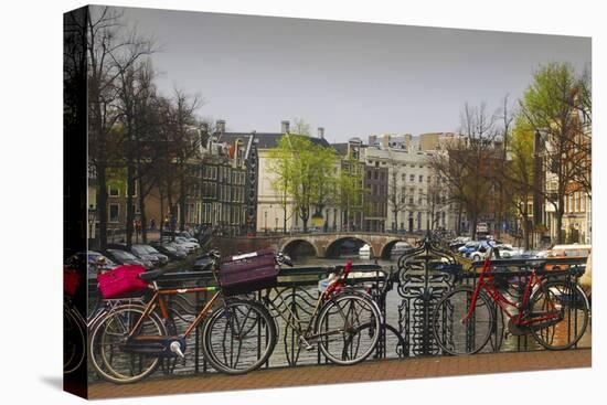 Amsterdam Bicycles on Bridge over Canal-Anna Miller-Stretched Canvas