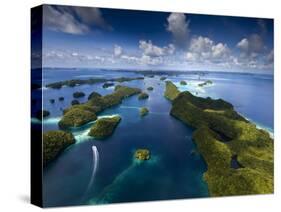 An Aerial View of a Boat as it Speeds Through the Rock Islands, Republic of Palau.-Ian Shive-Stretched Canvas