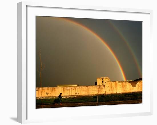 An Afghan Girl Walks Past Destroyed Buildings Occupied by Refugees-null-Framed Photographic Print