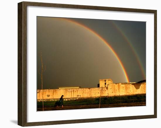 An Afghan Girl Walks Past Destroyed Buildings Occupied by Refugees-null-Framed Photographic Print