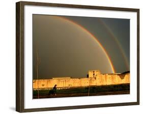 An Afghan Girl Walks Past Destroyed Buildings Occupied by Refugees-null-Framed Photographic Print