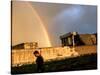 An Afghan Man Walks Past Destroyed Buildings Occupied by Refugees after a Heavy Rain-null-Stretched Canvas