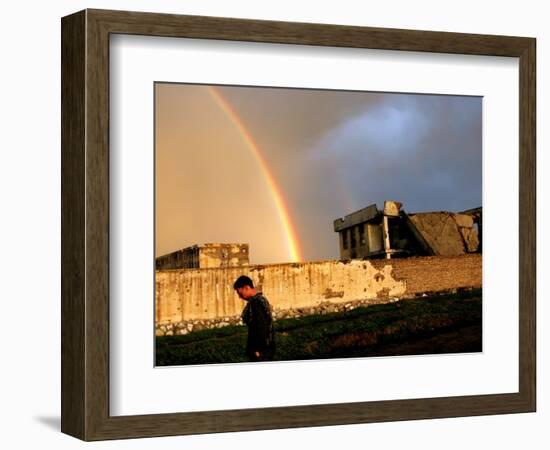 An Afghan Man Walks Past Destroyed Buildings Occupied by Refugees after a Heavy Rain-null-Framed Photographic Print