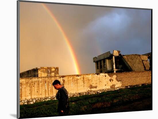 An Afghan Man Walks Past Destroyed Buildings Occupied by Refugees after a Heavy Rain-null-Mounted Photographic Print