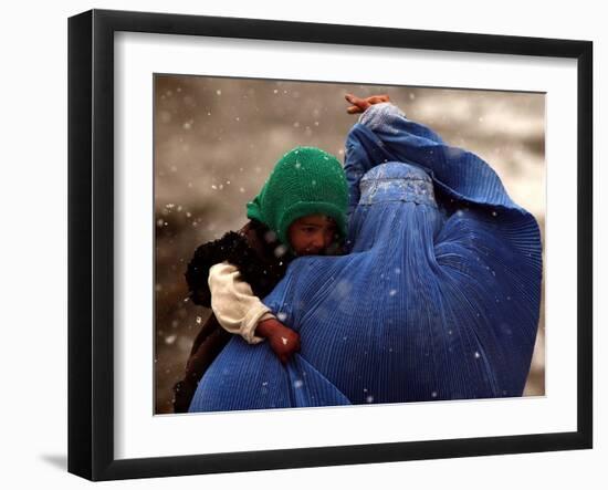 An Afghan Woman Holding Her Child Throws Back Her Burqa to See Her Way Along a Muddy Alley-null-Framed Photographic Print